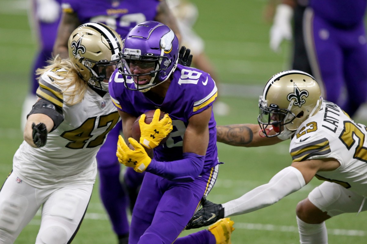 Minnesota Vikings receiver Justin Jefferson (18) runs between New Orleans Saints linebacker Alex Anzalone (47) and cornerback Marshon Lattimore (23) after a catch. Mandatory Credit: Chuck Cook-USA TODAY
